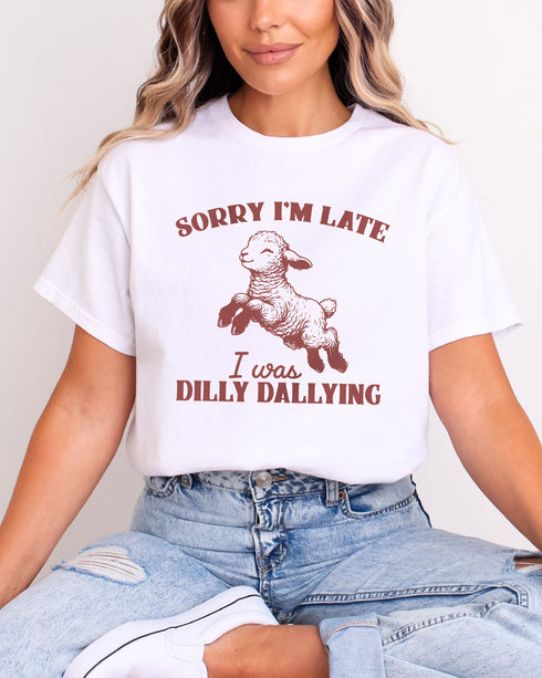 Woman wearing white color shirt with 'Sorry I'm Late I Was Dilly Dallying' graphic design